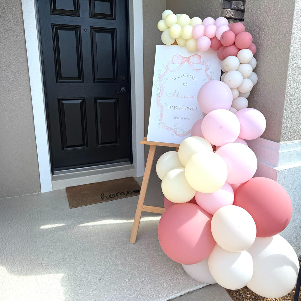 Baby Shower Easel with Balloon Garland organic balloon garland attached to entry way welcome sign