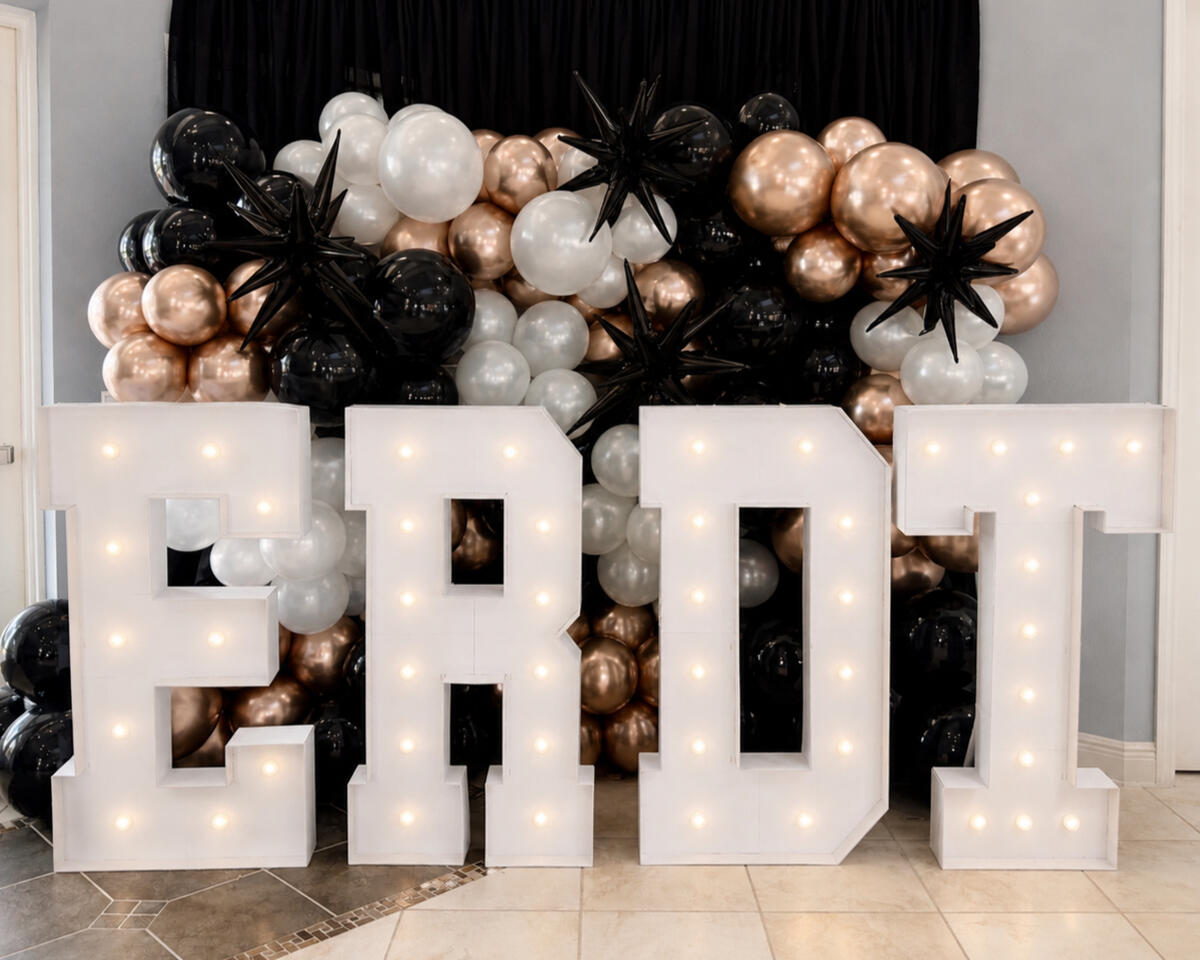 versized marquee letters paired with an organic balloon installation to create a statement photo opportunity for graduation celebrations and team banquets.