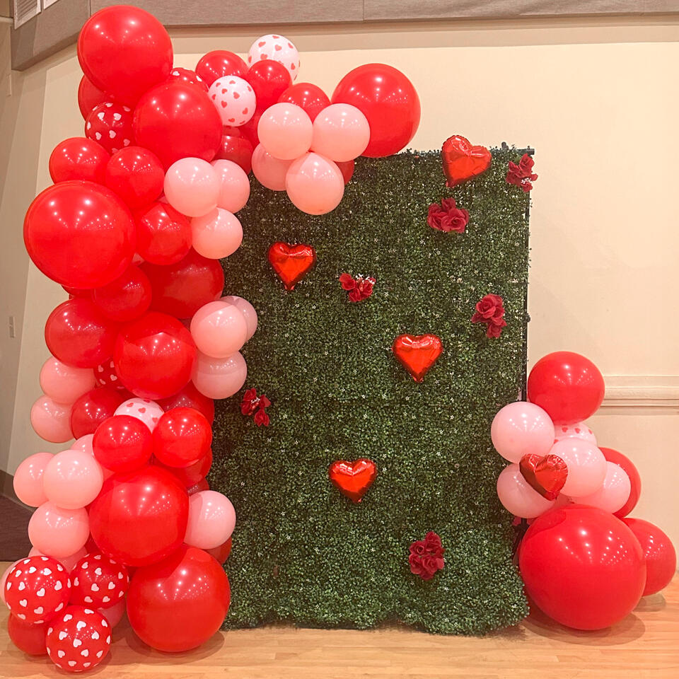 Valentine's Dance at WCA greenery wall with valentines themed organic garland