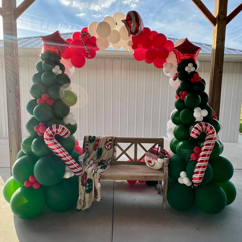 Company Holiday Party Custom Arch balloon garland for a company christmas party with holiday colors and accents