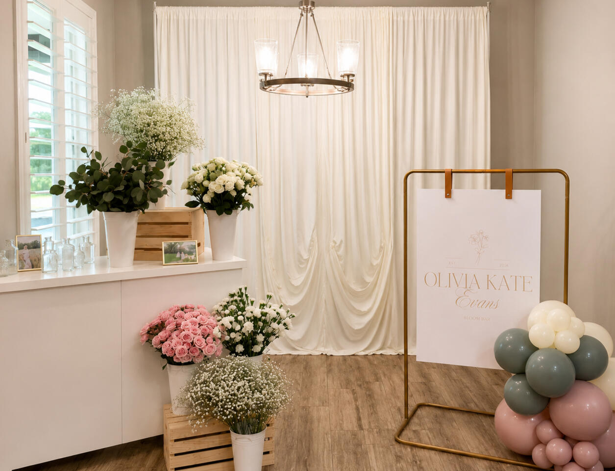 Soft draping, floral styling, and custom signage combined to create a refined focal point for bridal showers, baby showers, and special celebrations.