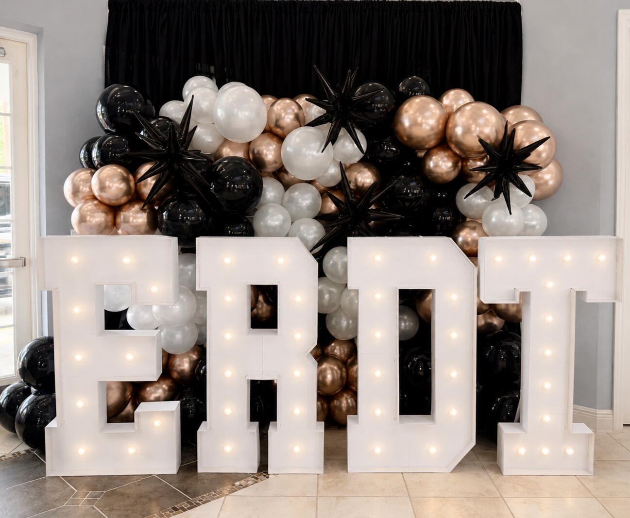 Untitlelluminated Graduation Featured Oversized marquee letters paired with an organic balloon installation to create a statement photo opportunity for graduation celebrations and team banquets. | Groveland, FL