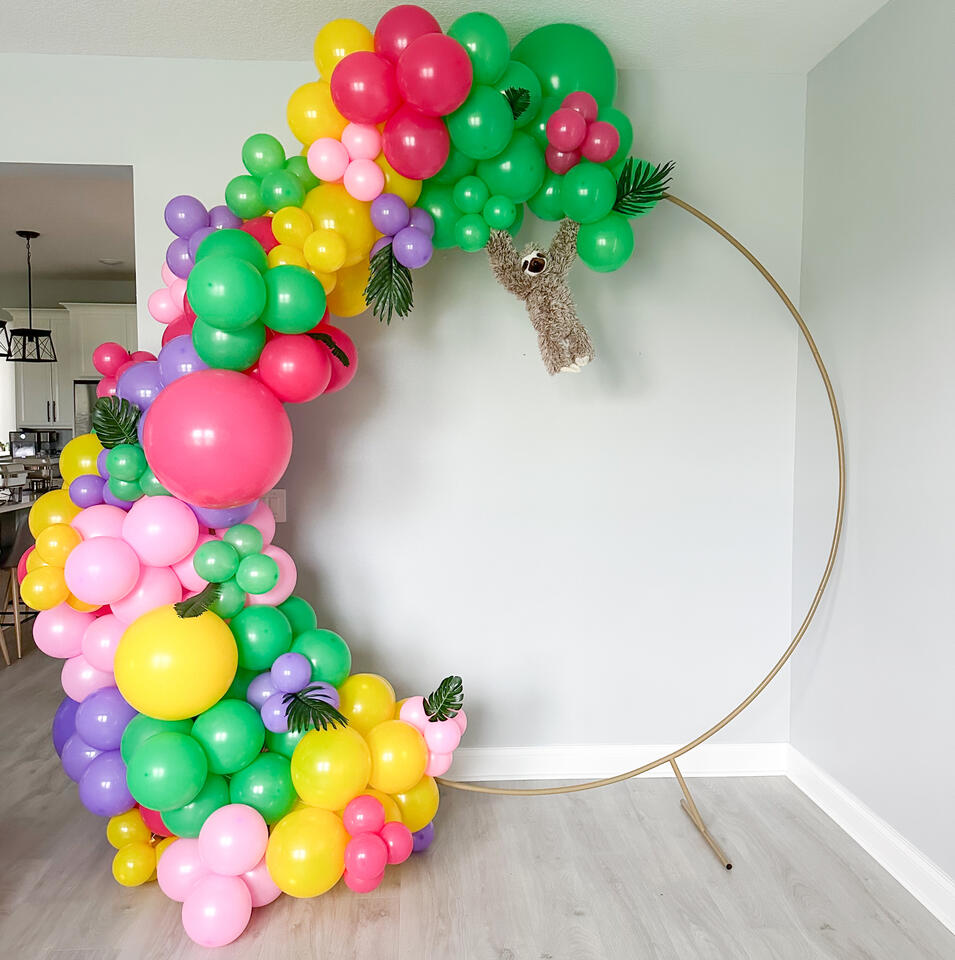 balloon hoop with bright colors and sloth props